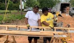 Fix It program members cutting wood for habitat for humanity